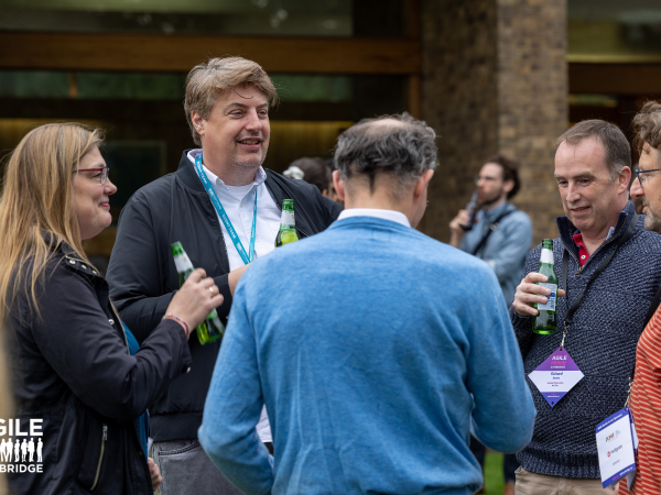 A group of people chatting and smiling