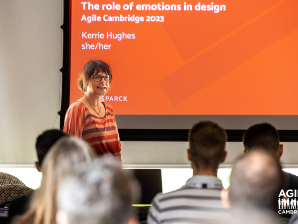 A person giving a presentation using a projector, with slides displayed on a screen.